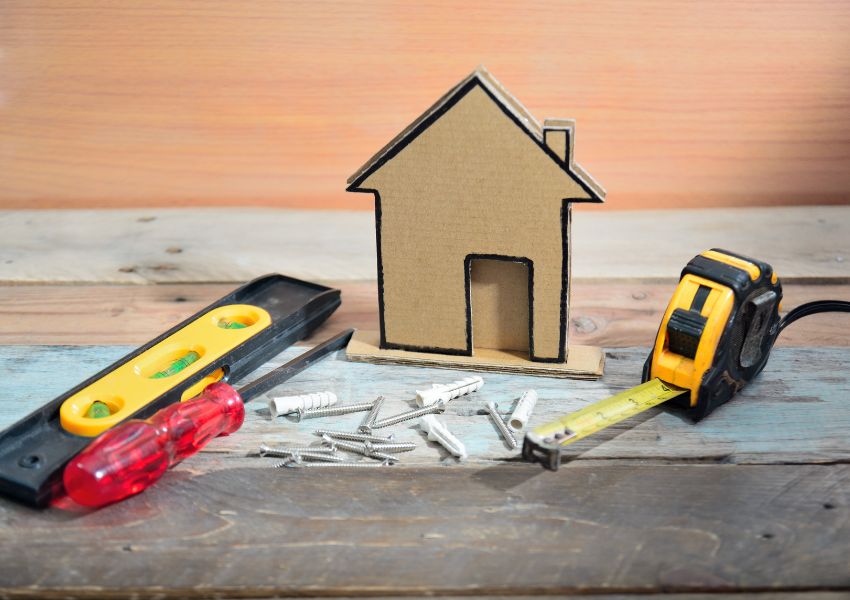 tools-with-wooden-house-cutout