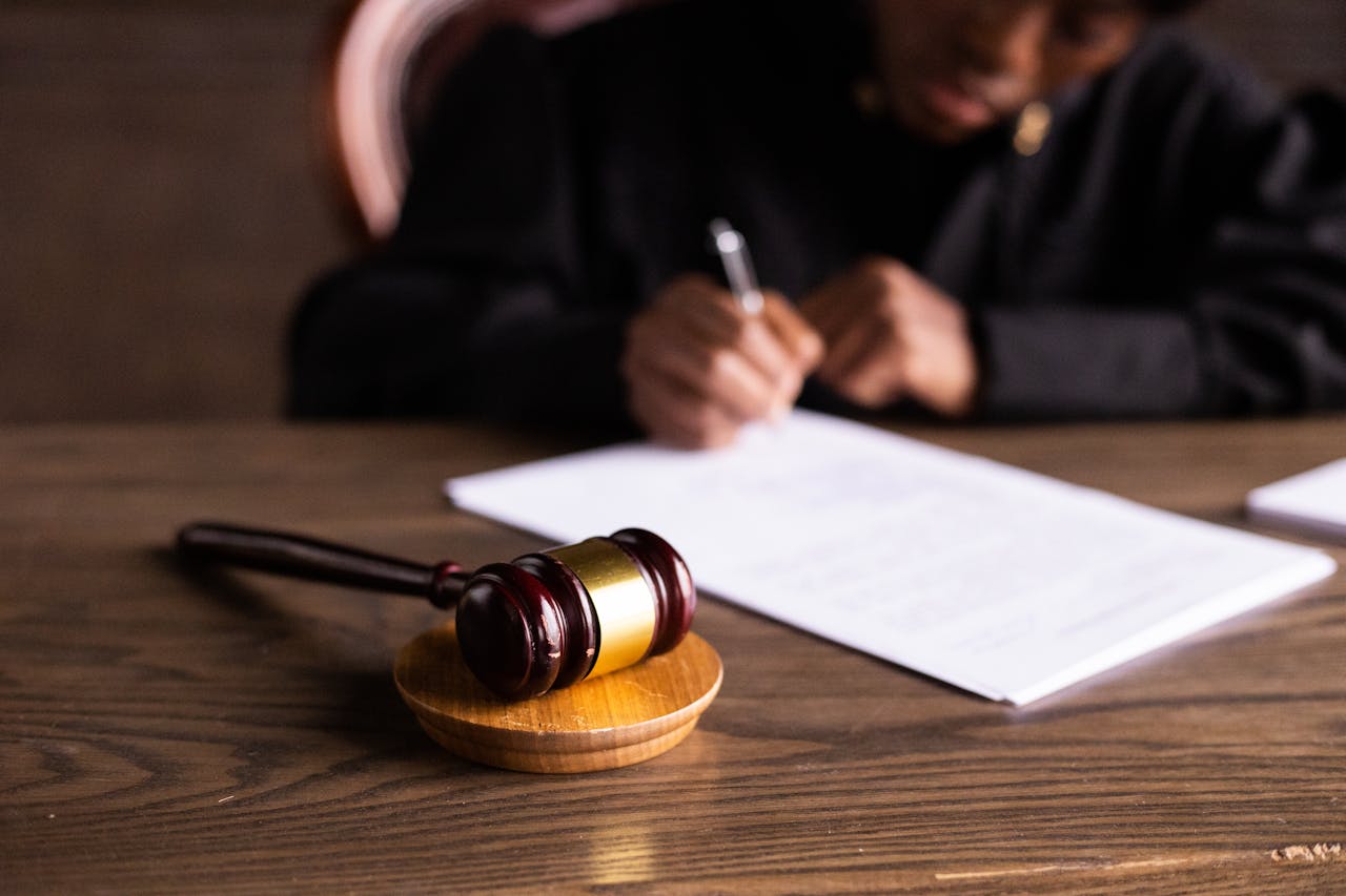 gavel in foreground person writing in background